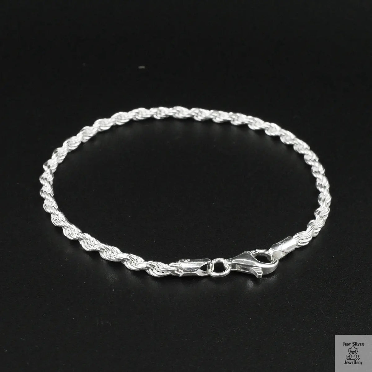 Silver rope bracelet on a black background