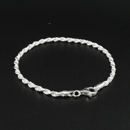 Silver rope bracelet on a black background