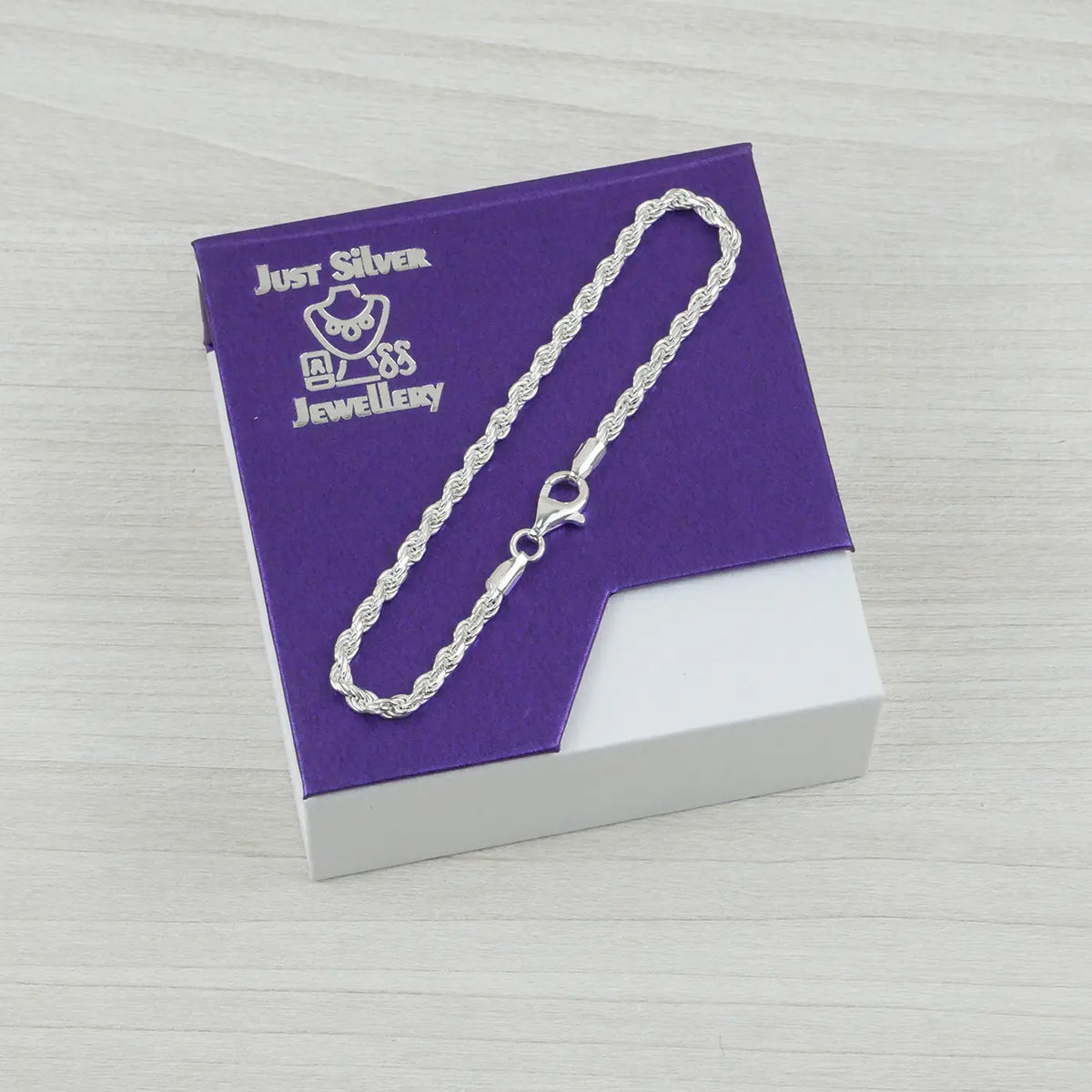 Silver rope bracelet on a purple card with 'Just Silver Jewellery' branding.