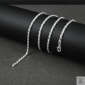 Silver rope chain on a dark surface