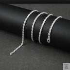 Silver rope chain on a dark surface
