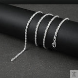 Silver rope chain on a dark surface