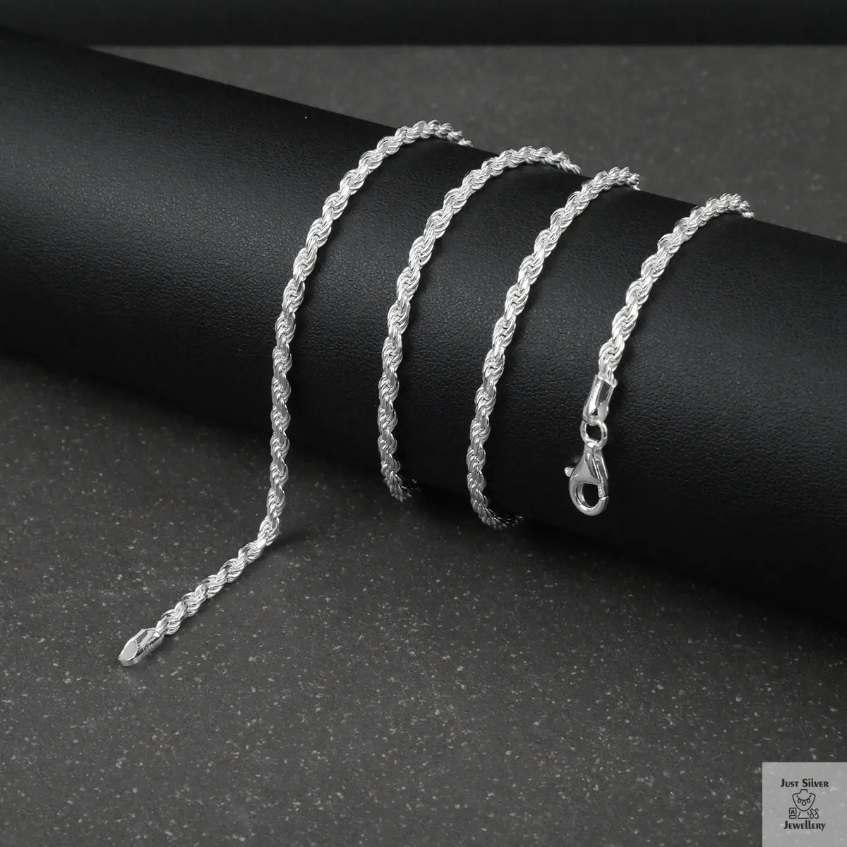 Silver rope chain on a dark surface