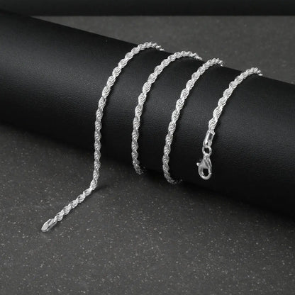 Silver rope chain on a dark surface