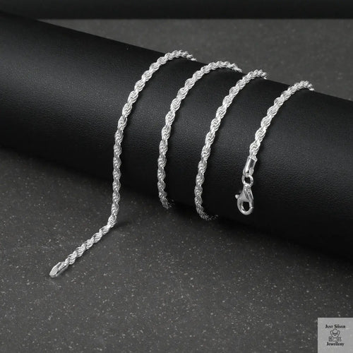 Silver rope chain on a dark surface