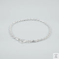 Silver rope bracelet on a light grey background