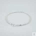 Silver rope bracelet on a light grey background