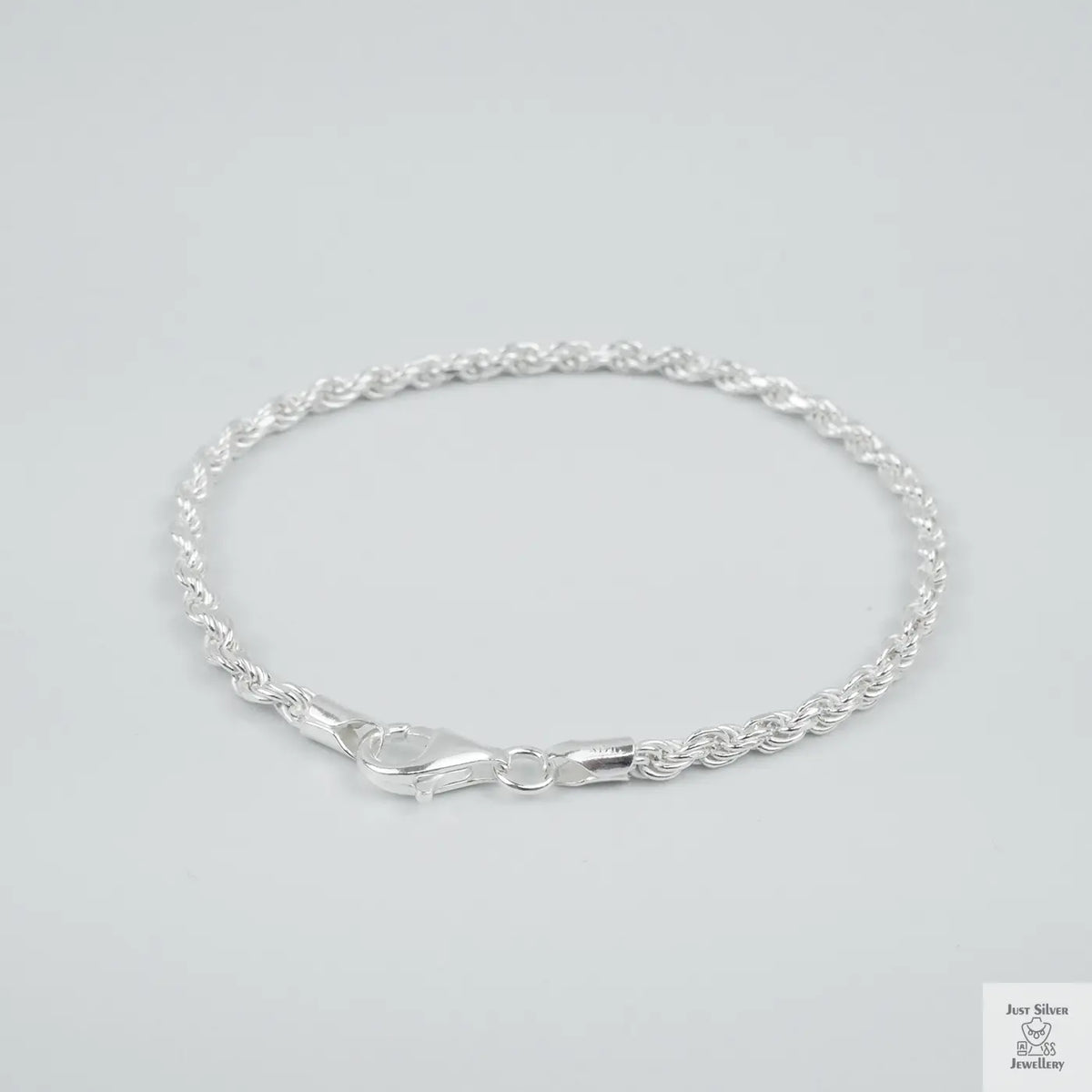 Silver rope bracelet on a light grey background