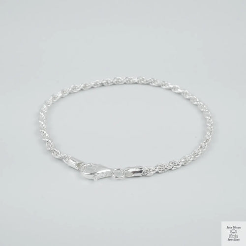 Silver rope bracelet on a light grey background