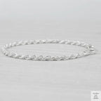 Silver rope bracelet on a light grey background
