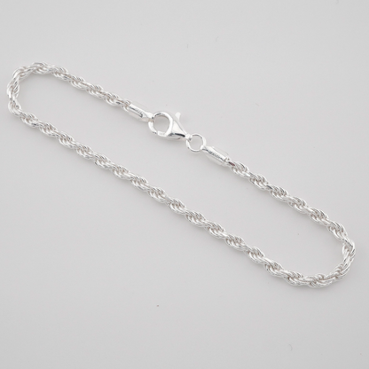 Silver chain necklace on a light gray background