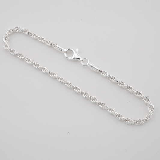 Silver chain necklace on a light gray background