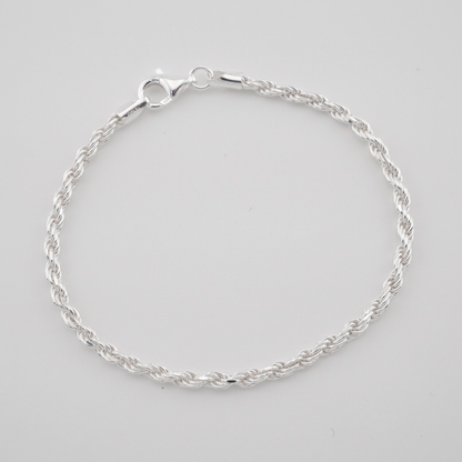 Silver bracelet on a light gray background
