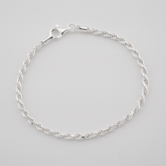Silver bracelet on a light gray background