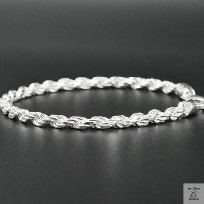 Silver rope bracelet on a black background