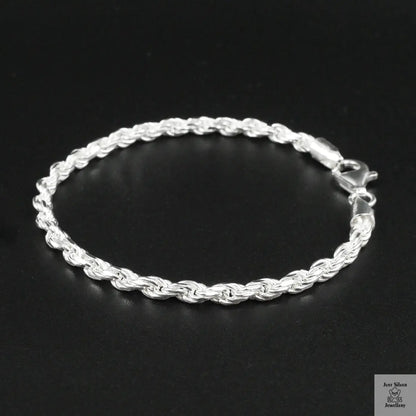 Silver rope bracelet on a black background