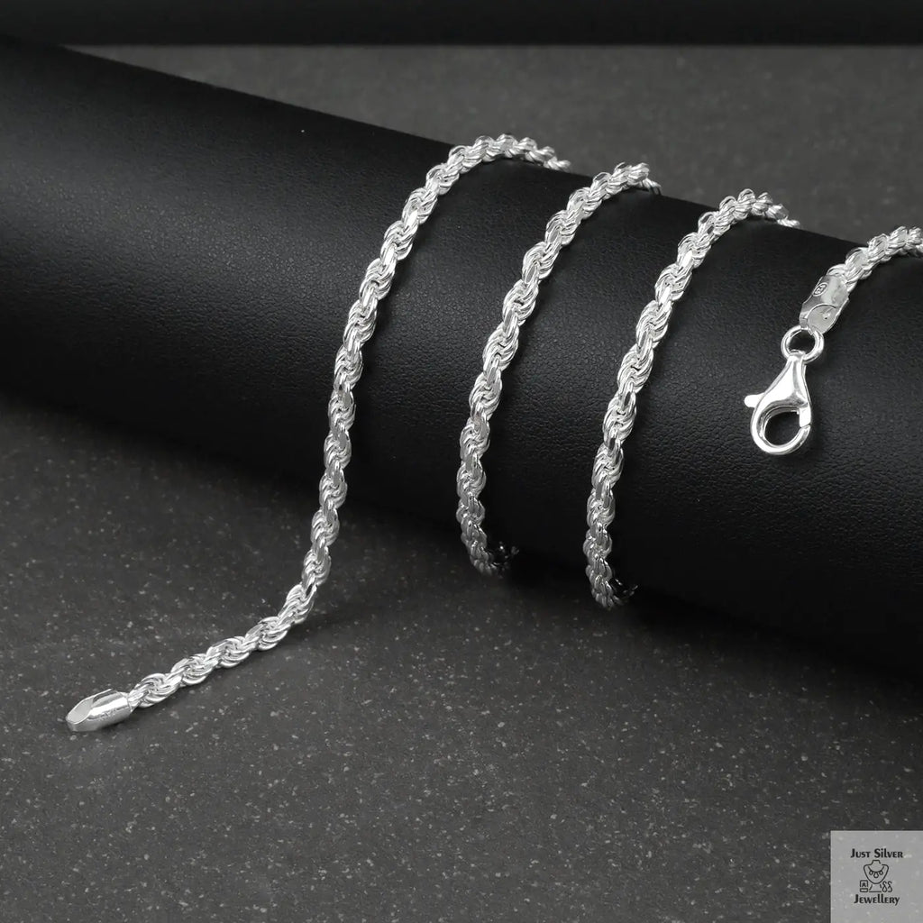 Silver rope chain on a black surface