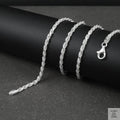 Silver rope chain on a black surface