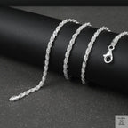Silver rope chain on a black surface