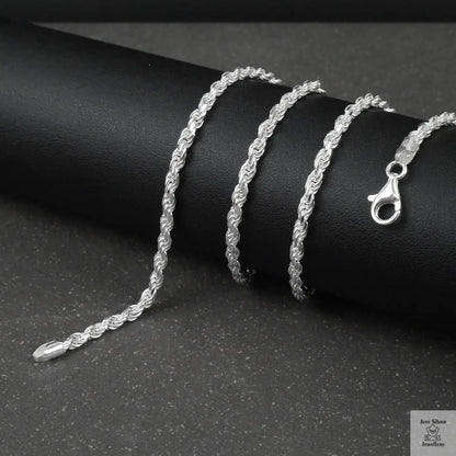 Silver rope chain on a black surface