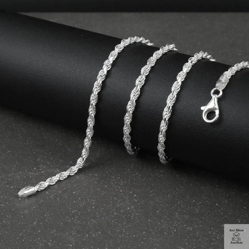 Silver rope chain on a black surface
