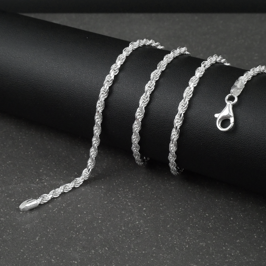 Silver rope chain on a black surface