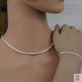 Silver rope necklace and bracelet set on a mannequin with a neutral background