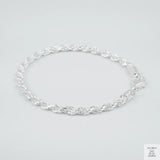 Silver rope bracelet on a light grey background