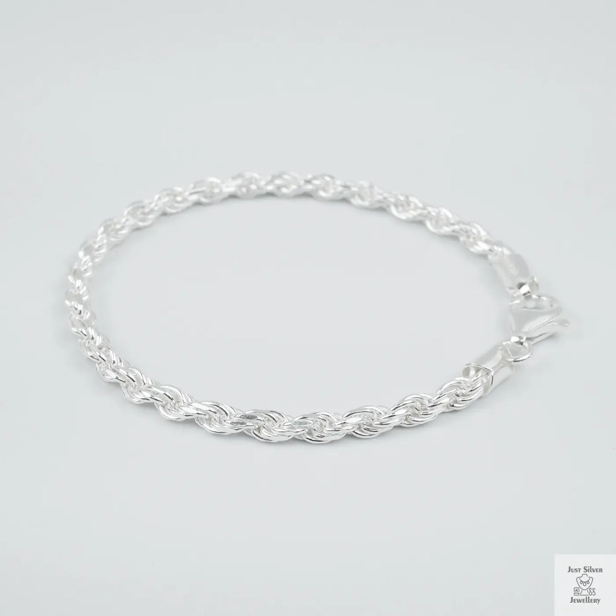 Silver rope bracelet on a light grey background