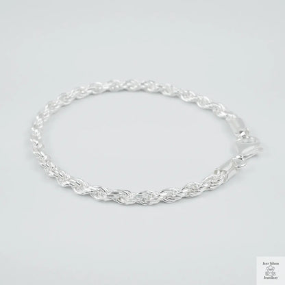 Silver rope bracelet on a light grey background