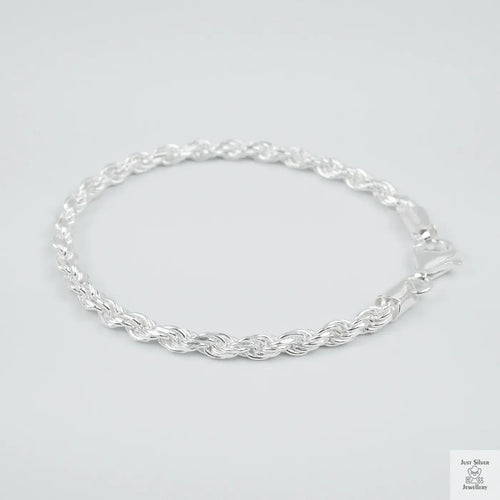 Silver rope bracelet on a light grey background
