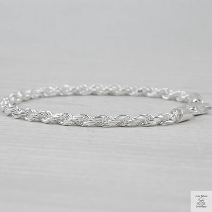 Silver rope bracelet on a light grey background