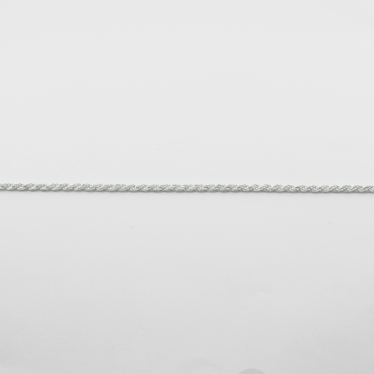 Silver chain on a light gray background