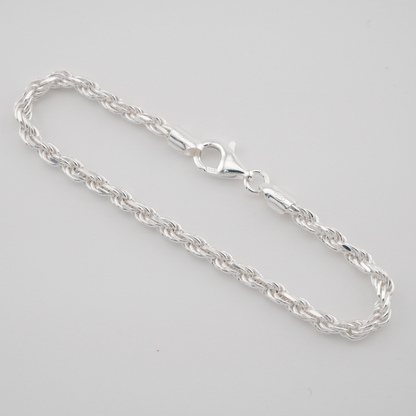 Silver chain bracelet on a light gray background