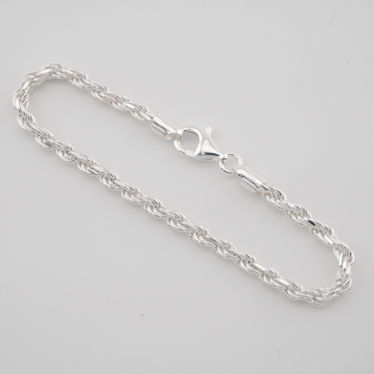 Silver chain bracelet on a light gray background