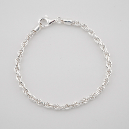 Silver bracelet on a light gray background