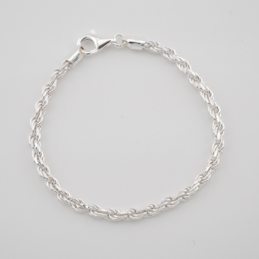 Silver bracelet on a light gray background