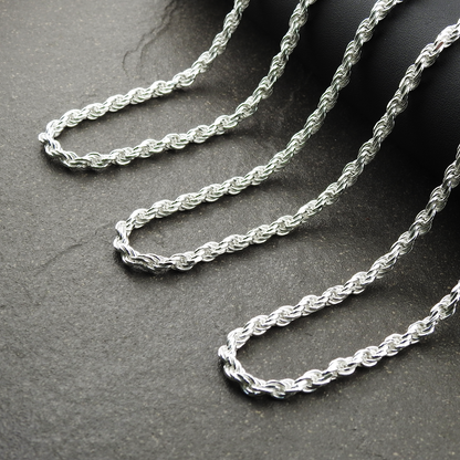 Silver rope chain on a dark surface
