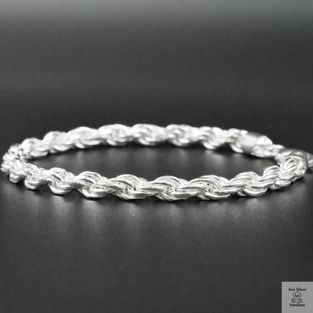 Silver rope bracelet on a dark surface