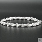 Silver rope bracelet on a dark surface