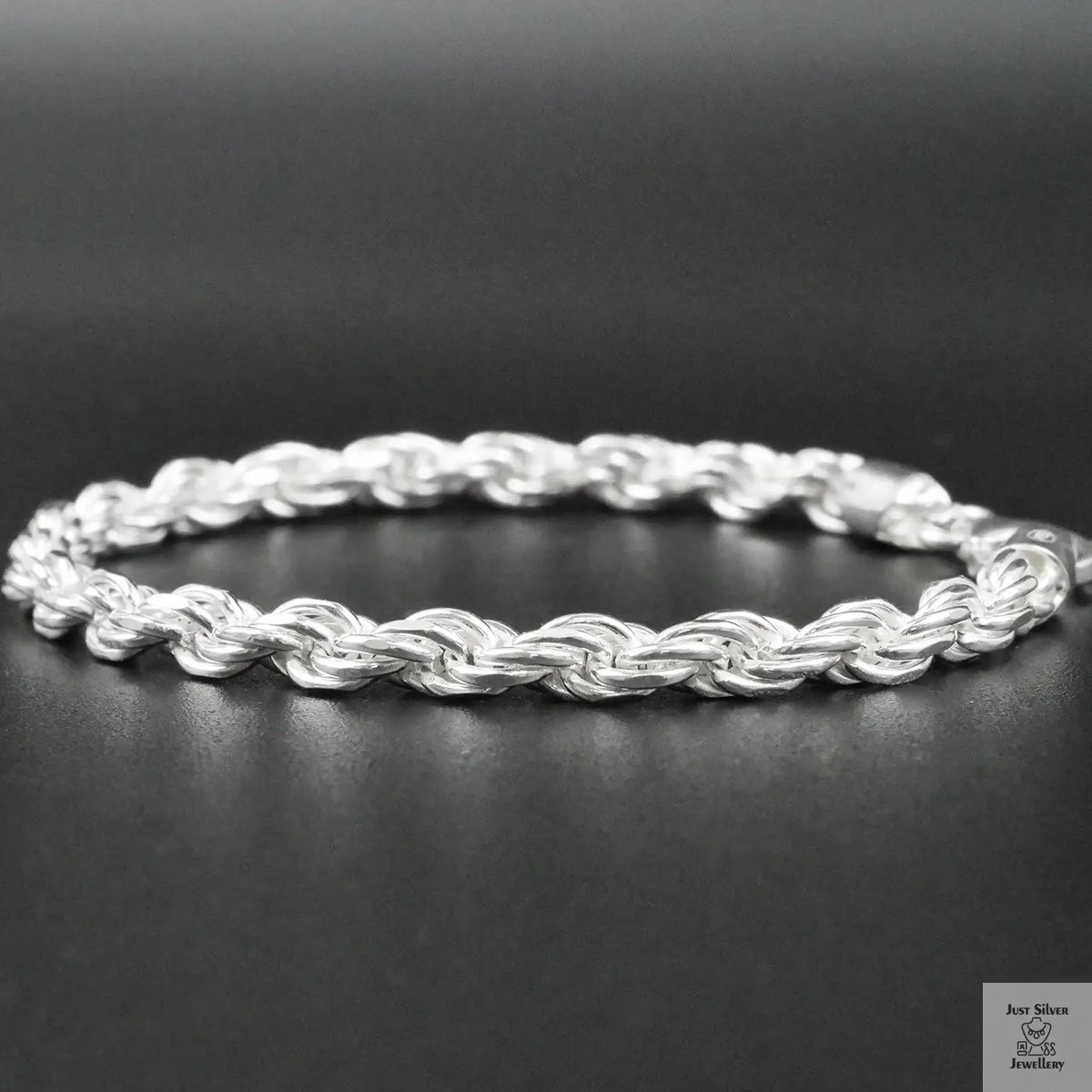 Silver rope bracelet on a dark surface