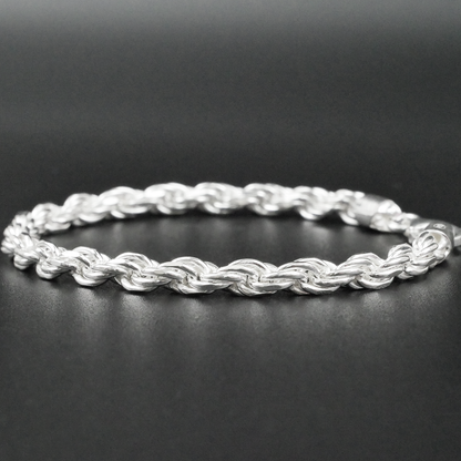 Silver rope bracelet on a dark surface