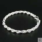 Silver rope bracelet on a black background