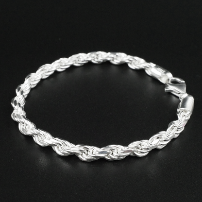 Silver rope bracelet on a black background