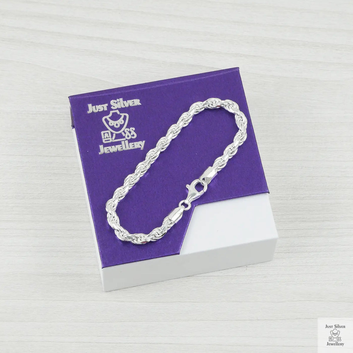 Silver bracelet on a purple card with 'Just Silver Jewellery' branding.