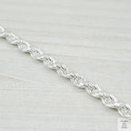 Silver chain on a light grey background