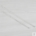 Silver bracelets on a light grey background