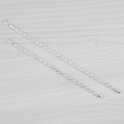 Silver bracelets on a light grey background