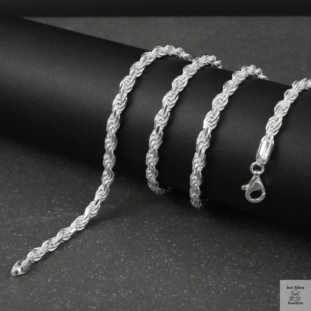 Silver rope chain on a black surface