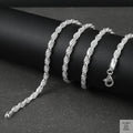 Silver rope chain on a black surface